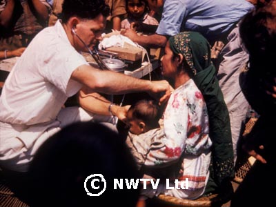 Alan examines a patient