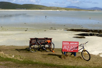 A plane comes in to land on the sandy beach that is Barra airport.