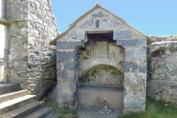 The grave of Donald MacCloud, which is only half in the church!