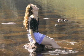 Arianne relaxes after scaling the broken dam at Dolgarrog*