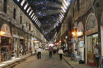 Rust holes in the corrugated iron canopy are the only illumination in Straight Street*